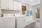 Convenient laundry room entry is perfect for dropping your towels after a day at the beach